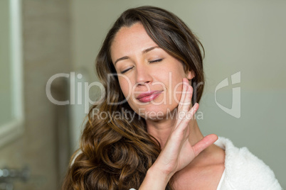 Close-up of beautiful woman touching her skin