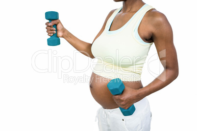 Pregnant woman lifting dumbbell