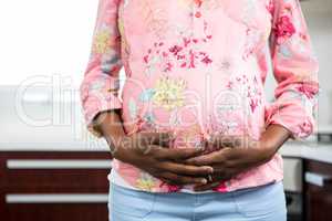 Pregnant woman touching belly