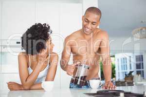 Happy couple drinking coffee in the kitchen