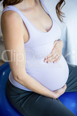 Pregnant woman sitting on exercise ball