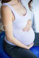 Pregnant woman sitting on exercise ball