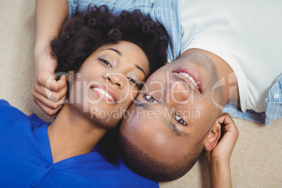 Portrait of smiling couple lying on the floor