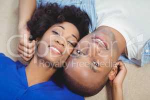 Portrait of smiling couple lying on the floor