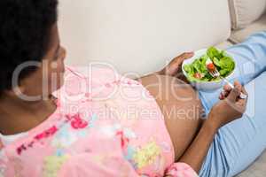 Pregnant woman eating salad