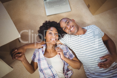 Happy couple lying on the floor