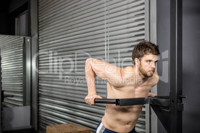 Shirtless man doing pull up