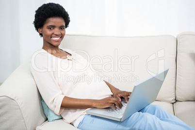 Pregnant woman using laptop