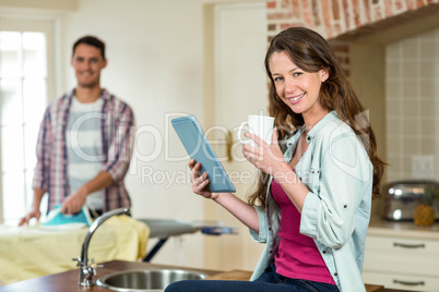 Woman using tablet in kitchen