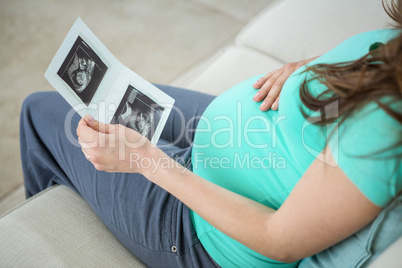 Pregnant woman looking at ultrasound scans