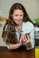 Portrait of young woman text messaging on mobile phone