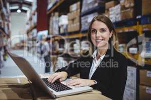 Warehouse manager using laptop