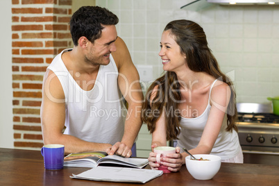 Young couple looking at each other in kitchen
