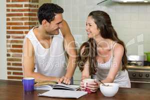 Young couple looking at each other in kitchen