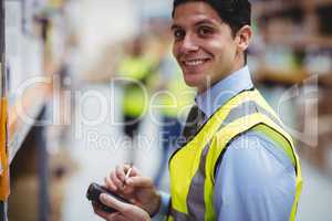 Warehouse worker using hand scanner