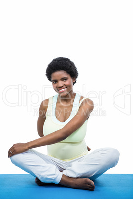 Pregnant woman meditating on mat