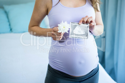 Pregnant woman holding an ultrasound