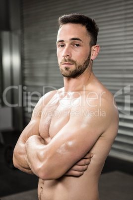 Portrait of shirtless man with arms crossed