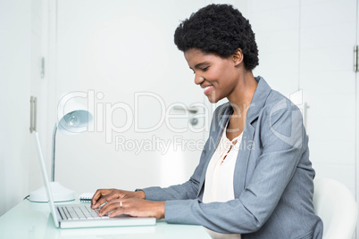 Pregnant businesswoman using laptop