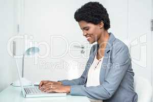 Pregnant businesswoman using laptop