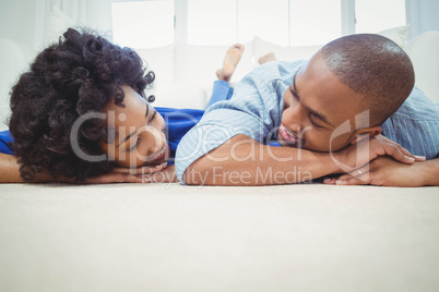 Smiling couple lying on the floor