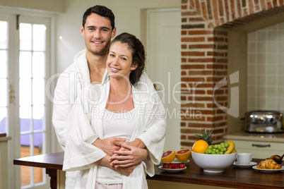 Couple in bathrobe embracing each other