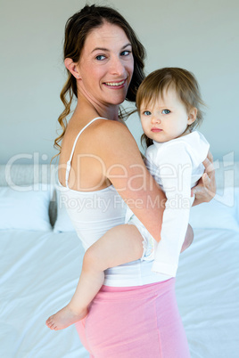 smiling woman holding an adorable baby