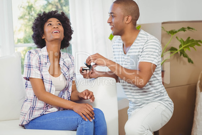 handsome man offering engagement ring to his girlfriend