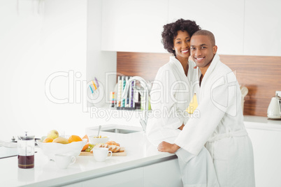 Happy couple hugging in the kitchen