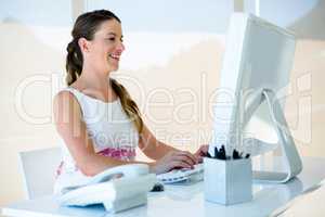 smiling businesswoman on her computer