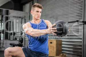 Muscular man training with medicine ball