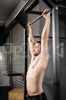 Muscular man doing pull up