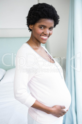 Pregnant woman touching her belly