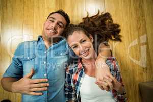 Young couple lying on floor in their house