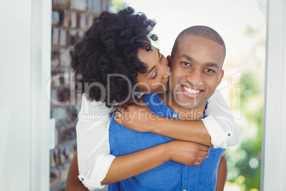 Handsome man giving piggy back to his girlfriend