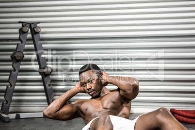 Shirtless man doing abdominal crunches