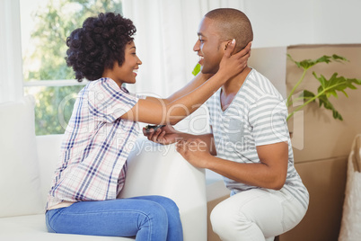 handsome man offering engagement ring to his girlfriend