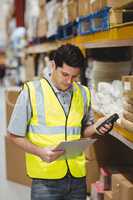 Warehouse worker looking at clipboard