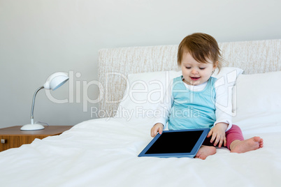 adorable baby holding a tablet computer