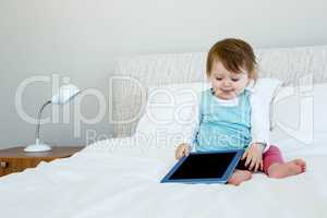 adorable baby holding a tablet computer