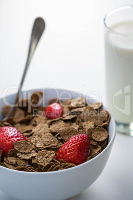 View of a bowl of cereals and glass of milk