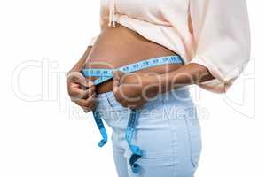 Pregnant woman measuring her belly