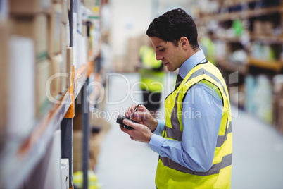 Warehouse worker using hand scanner