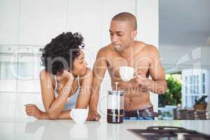 Happy couple drinking coffee in the kitchen