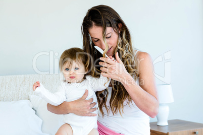 playful baby trying to comb a womans hair