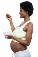 Pregnant woman eating fruit salad