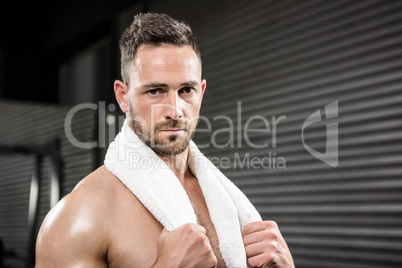 Portrait of shirtless man with towel around neck