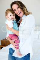 smiling woman holding n adorable baby