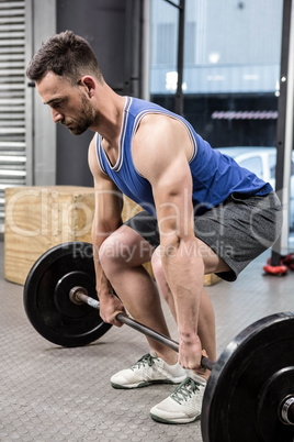 Muscular man lifting barbell