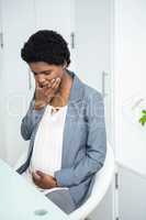 Pregnant businesswoman feeling sick